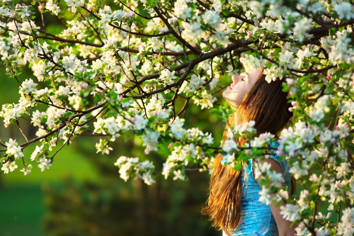 Young woman in spring orchard